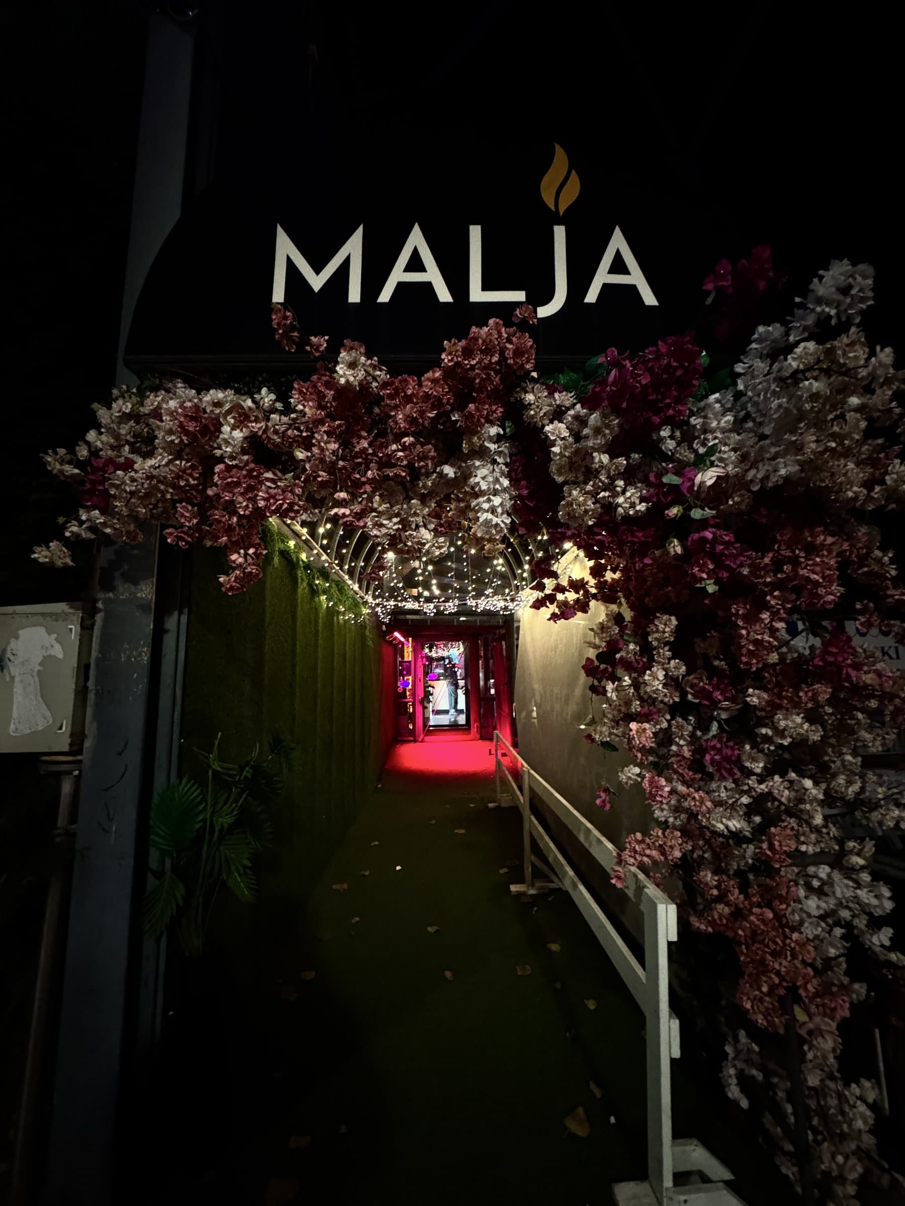 Malja's entrance: the Malja sign and the flower arch